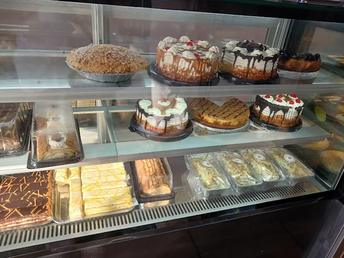 The Krispy Bun cake counter lined with cheesecakes, tarts and cream slices